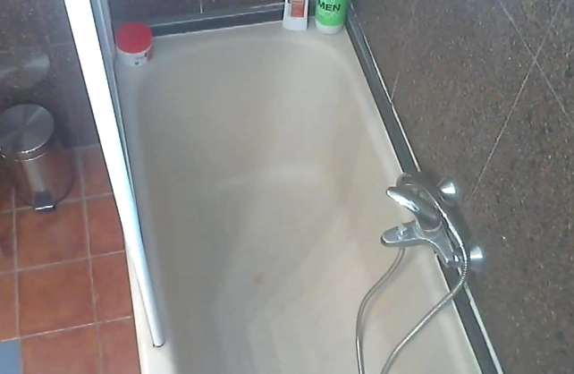 Busty nude female caught on cam when showering and fingering her twat