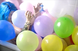 Crazy girl plays a cosplay solo in the shower having fun with toy balloons