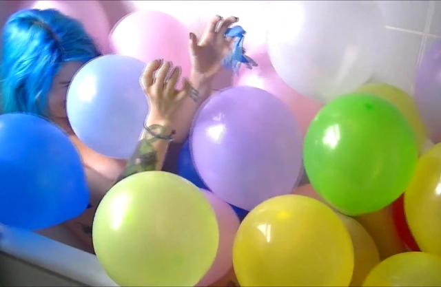 Crazy girl plays a cosplay solo in the shower having fun with toy balloons