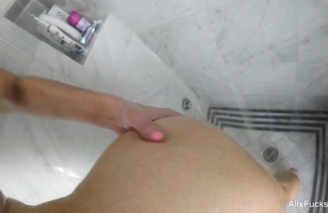 Blonde bitch with huge fake tits loves being filmed masturbating in the shower